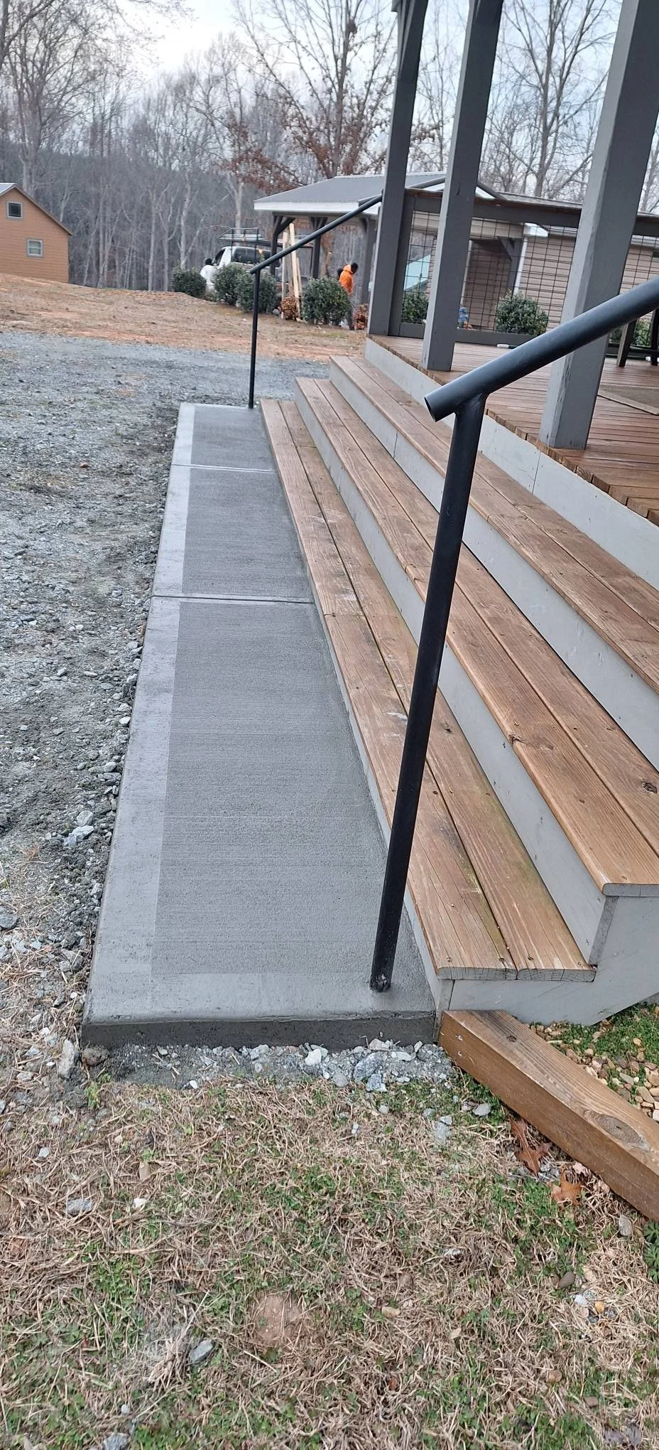 Concrete landing with deck stairs